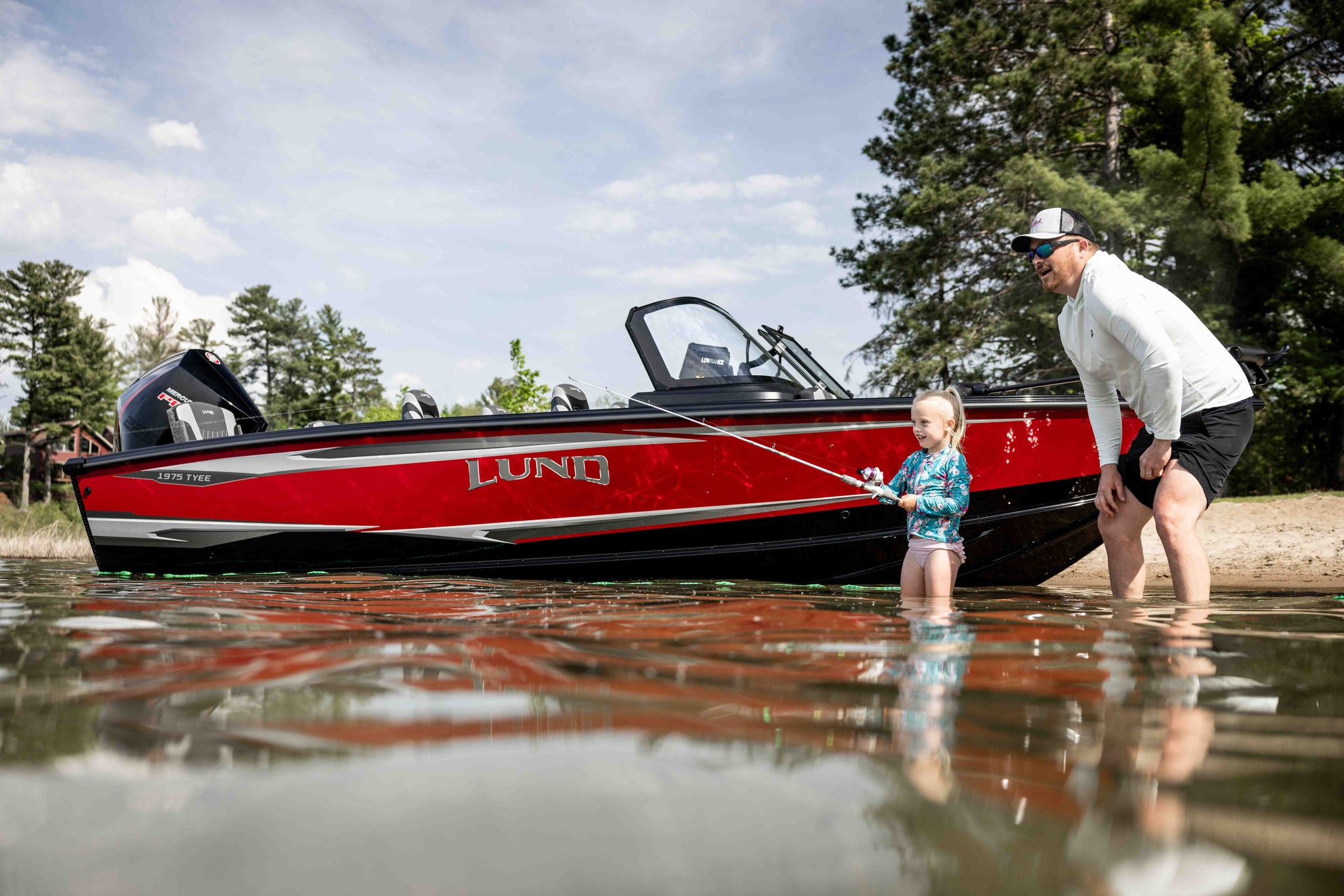 Fishing with a child next to a beached Lund 1975 Tyee