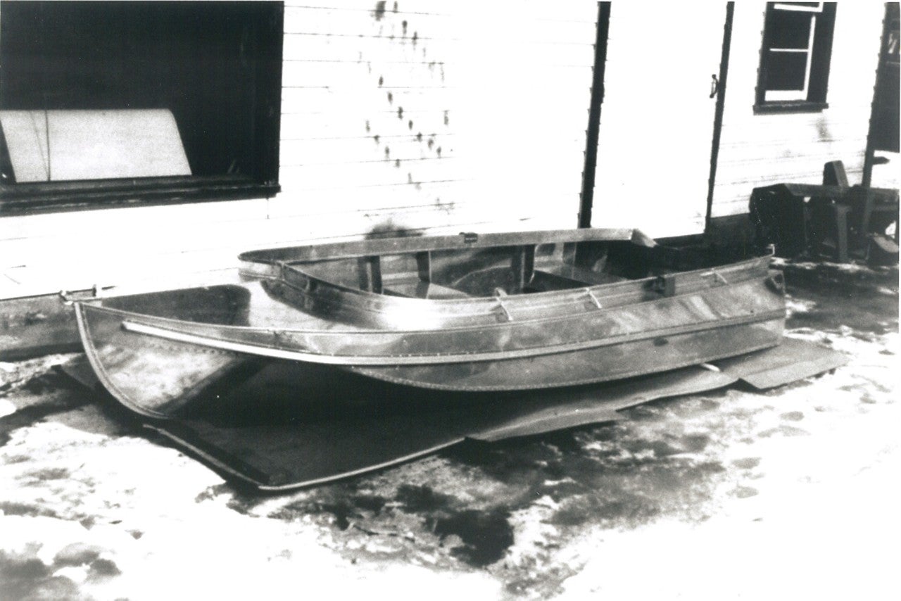 Old black and white photo of a Lund boat